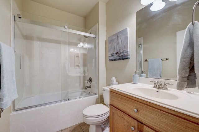full bathroom with tile patterned flooring, vanity, enclosed tub / shower combo, and toilet