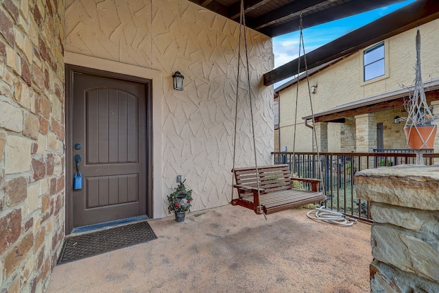 entrance to property featuring stucco siding