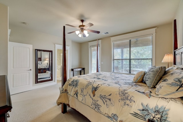 bedroom with ceiling fan, carpet flooring, ensuite bathroom, and visible vents