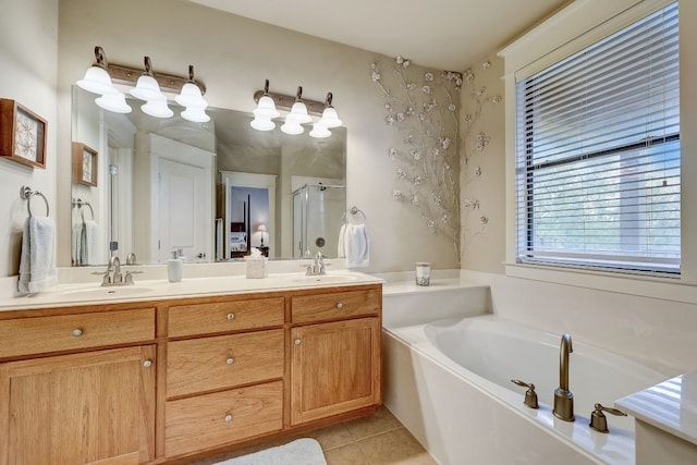 full bath with a shower stall, a garden tub, tile patterned floors, and a sink