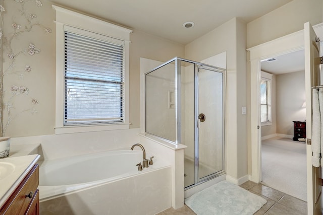 bathroom with a shower stall, a garden tub, vanity, and tile patterned floors