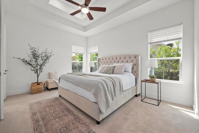 206 Olivia Dr Unit 120, Austin, TX 78738 - bedroom featuring light colored carpet, a raised ceiling, baseboards, and a ceiling fan