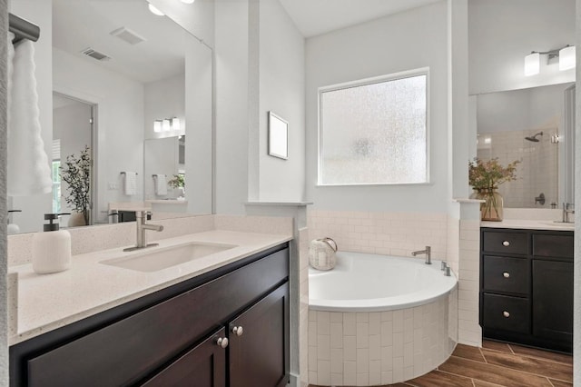 206 Olivia Dr Unit 120, Austin, TX 78738 - bathroom with vanity, a tile shower, a bath, and plenty of natural light