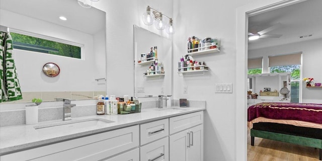 4711 Little Hill Cir, Austin, TX 78725 - ensuite bathroom featuring double vanity, healthy amount of natural light, a ceiling fan, and wood finished floors