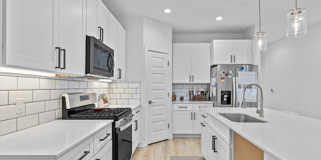 4711 Little Hill Cir, Austin, TX 78725 - kitchen with appliances with stainless steel finishes, a sink, recessed lighting, white cabinets, and light wood-style floors