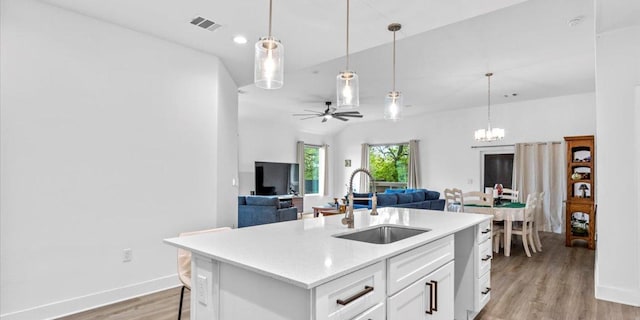 4711 Little Hill Cir, Austin, TX 78725 - kitchen with a sink, light wood-style flooring, light countertops, white cabinetry, and ceiling fan