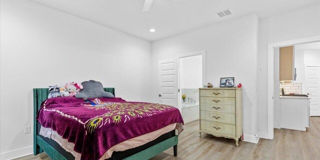 4711 Little Hill Cir, Austin, TX 78725 - bedroom with ensuite bathroom, baseboards, light wood finished floors, and visible vents