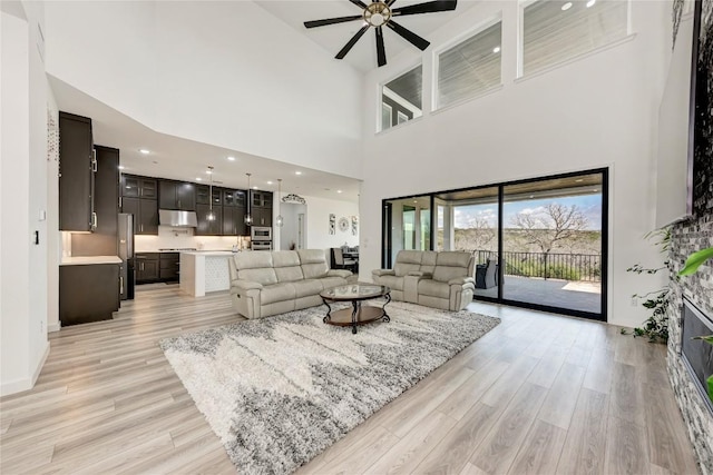2420 Novara Trl, Leander, TX 78641 - living room with ceiling fan, light wood-style flooring, and a high ceiling