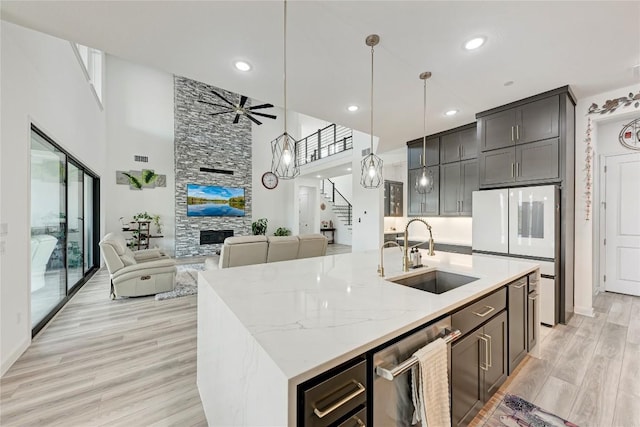 2420 Novara Trl, Leander, TX 78641 - kitchen featuring a high ceiling, open floor plan, dishwasher, white fridge, and a ceiling fan
