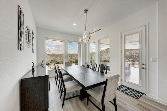 2420 Novara Trl, Leander, TX 78641 - dining space featuring a chandelier, healthy amount of natural light, light wood-style flooring, and recessed lighting