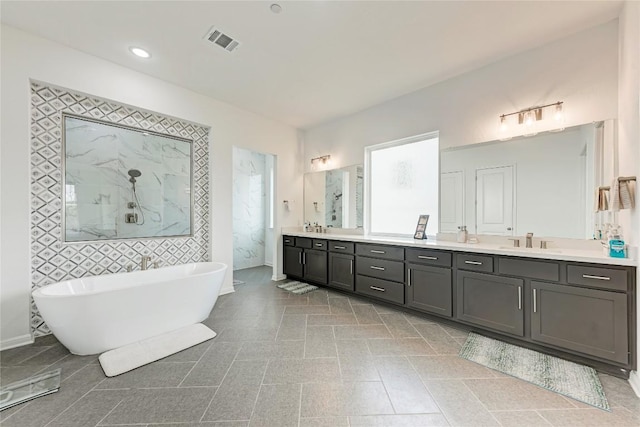 2420 Novara Trl, Leander, TX 78641 - full bathroom featuring double vanity, a freestanding tub, and walk in shower