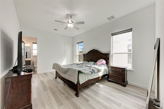 2420 Novara Trl, Leander, TX 78641 - bedroom featuring light wood-style flooring, a ceiling fan, and connected bathroom