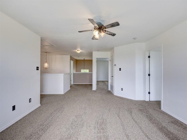 335 Dandelion Loop, Kyle, TX 78640 - unfurnished room featuring light colored carpet, a ceiling fan, and attic access