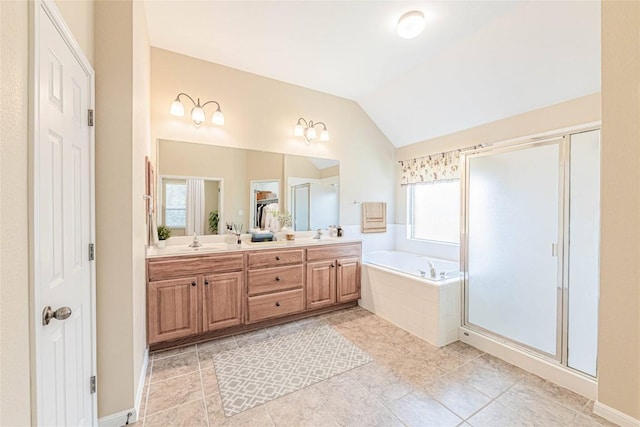 2009 Tillman Dr, Cedar Park, TX 78613 - bathroom with double vanity, a garden tub, vaulted ceiling, a stall shower, and tile patterned flooring