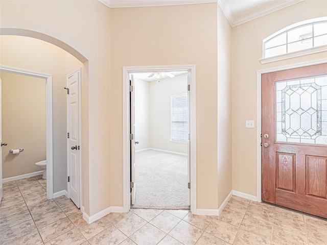2009 Tillman Dr, Cedar Park, TX 78613 - entrance foyer with arched walkways, crown molding, light tile patterned floors, and a towering ceiling