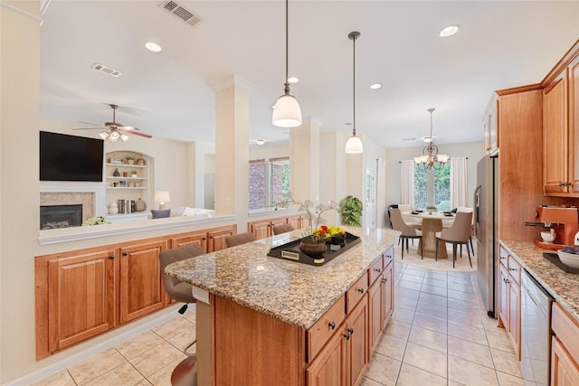 2009 Tillman Dr, Cedar Park, TX 78613 - kitchen featuring ceiling fan, light tile patterned floors, a center island, a fireplace, and stainless steel appliances