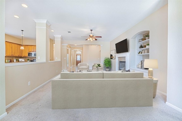 2009 Tillman Dr, Cedar Park, TX 78613 - living room with a fireplace, ceiling fan, light colored carpet, recessed lighting, and built in shelves