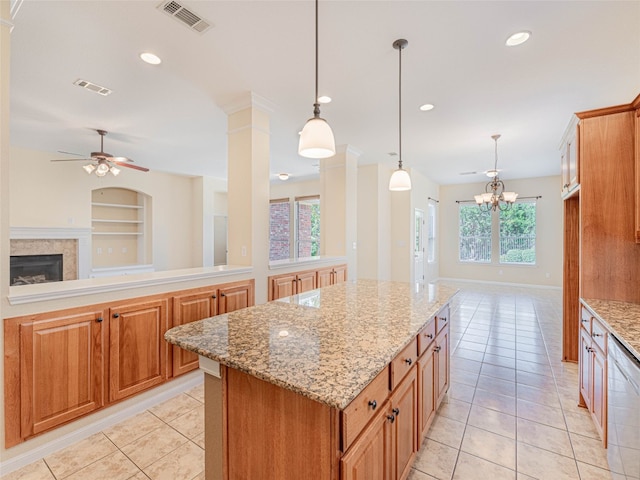 2009 Tillman Dr, Cedar Park, TX 78613 - kitchen with open floor plan, light tile patterned floors, dishwasher, a kitchen island, and a glass covered fireplace