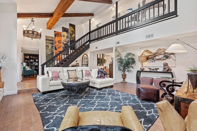 2906 Quail Run Dr, Round Rock, TX 78681 - living area featuring hardwood / wood-style flooring, beamed ceiling, stairway, a chandelier, and a towering ceiling