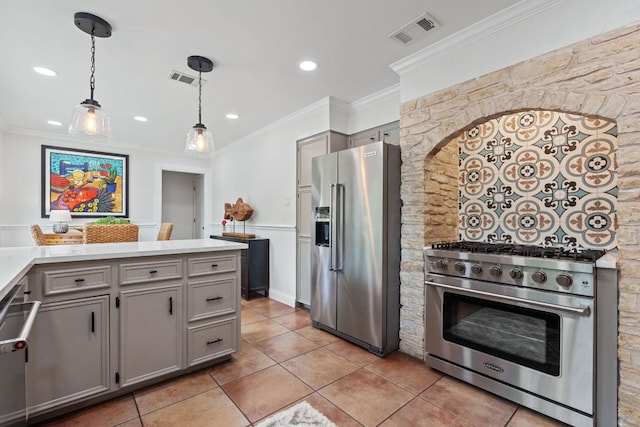 2906 Quail Run Dr, Round Rock, TX 78681 - kitchen with high quality appliances, gray cabinets, light tile patterned floors, ornamental molding, and recessed lighting