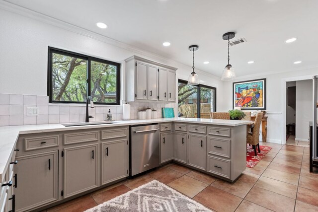 2906 Quail Run Dr, Round Rock, TX 78681 - kitchen featuring stainless steel dishwasher, gray cabinetry, a peninsula, tasteful backsplash, and crown molding