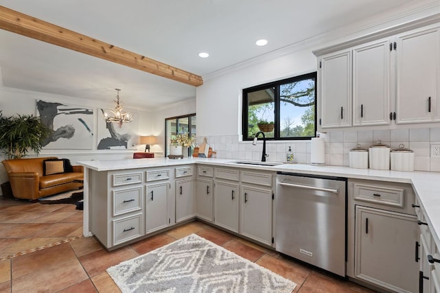 kitchen featuring a sink, light countertops, a peninsula, stainless steel dishwasher, and decorative backsplash