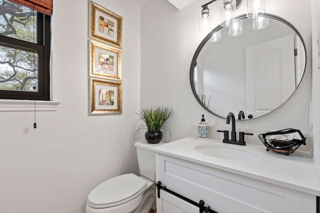 half bath featuring toilet and vanity