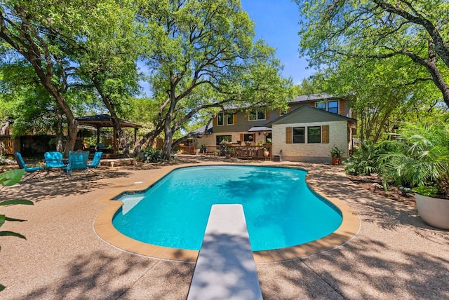 2906 Quail Run Dr, Round Rock, TX 78681 - swimming pool with a gazebo, a diving board, a deck, and a patio area