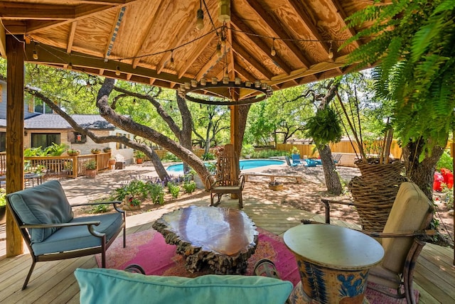 view of patio / terrace with a gazebo, a fenced in pool, a deck, and fence