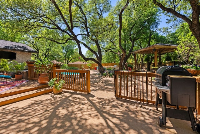 view of patio with a gazebo, fence, and a deck