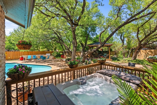 2906 Quail Run Dr, Round Rock, TX 78681 - wooden deck with a gazebo, an outdoor hot tub, a patio area, and a fenced backyard
