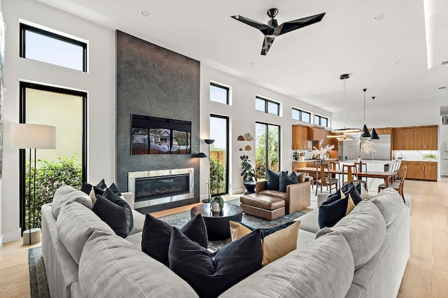 2116 Kenwood Ave, Austin, TX 78704 - living area featuring a high ceiling, a ceiling fan, a fireplace, light wood-type flooring, and recessed lighting
