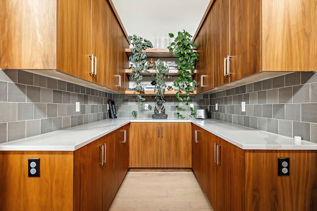 2116 Kenwood Ave, Austin, TX 78704 - kitchen with brown cabinetry, tasteful backsplash, and open shelves