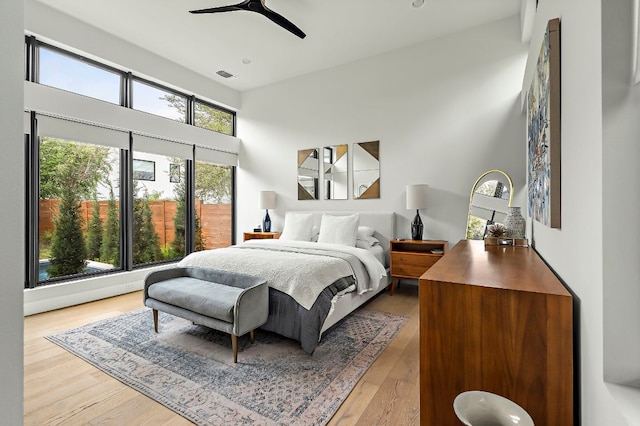 2116 Kenwood Ave, Austin, TX 78704 - bedroom featuring wood finished floors, a high ceiling, and a ceiling fan