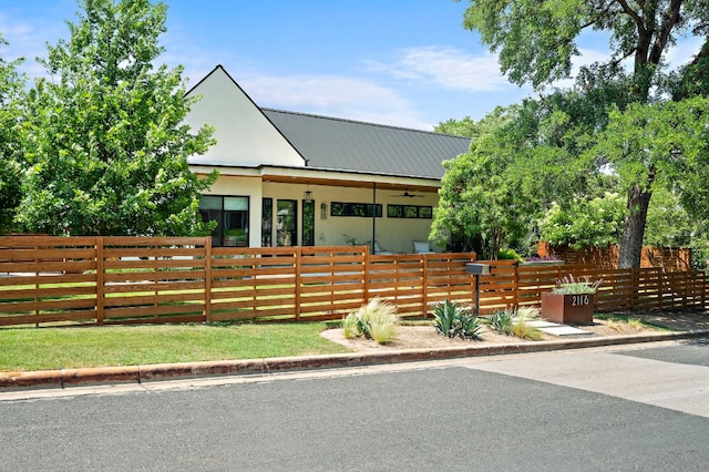 2116 Kenwood Ave, Austin, TX 78704 - view of front of house featuring a fenced front yard, stucco siding, and metal roof