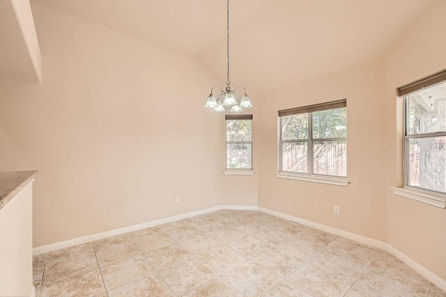 empty room with baseboards, lofted ceiling, an inviting chandelier, and light tile patterned floors