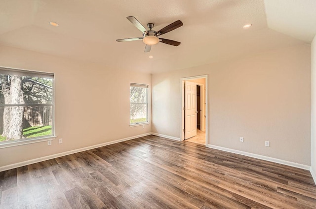 spare room featuring baseboards, wood finished floors, recessed lighting, a ceiling fan, and lofted ceiling