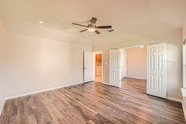unfurnished bedroom with visible vents, baseboards, washer / clothes dryer, wood finished floors, and recessed lighting