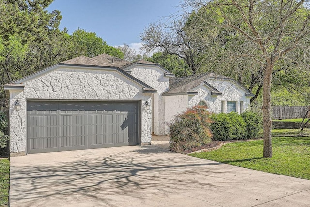 view of front of home featuring driveway, a front yard, an attached garage, and stucco siding