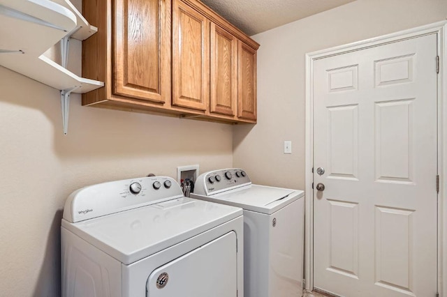 laundry area with cabinet space and independent washer and dryer