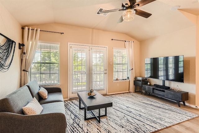living room with visible vents, wood finished floors, lofted ceiling, baseboards, and a ceiling fan