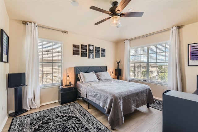 9201 Brodie Ln Unit 201, Austin, TX 78748 - bedroom with multiple windows, light wood-style flooring, and a ceiling fan