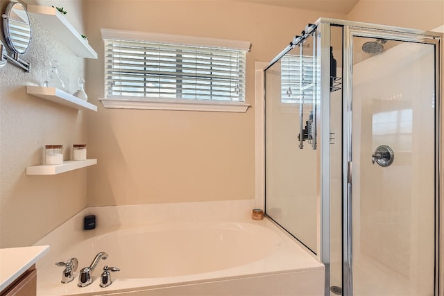 bathroom with vanity, a garden tub, and a stall shower