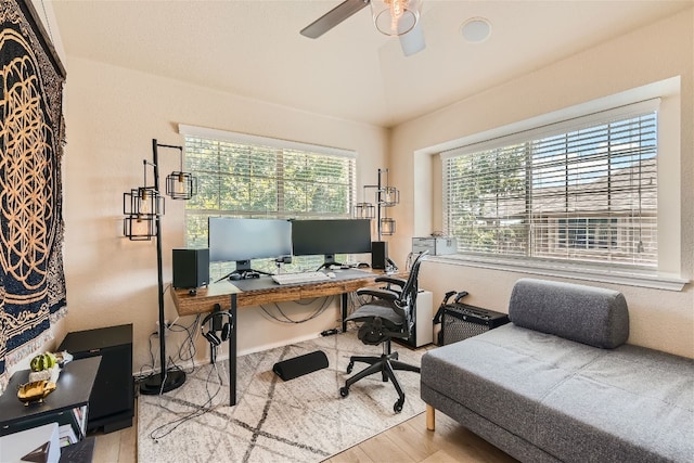 office space featuring a ceiling fan, vaulted ceiling, and wood finished floors