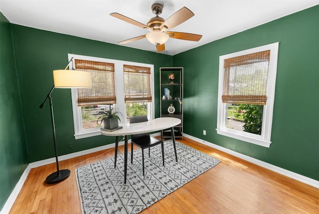 2108 Rountree Dr, Austin, TX 78722 - home office featuring wood finished floors, baseboards, and a ceiling fan