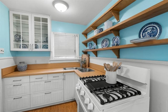 2108 Rountree Dr, Austin, TX 78722 - kitchen with white gas range, a sink, open shelves, and white cabinetry