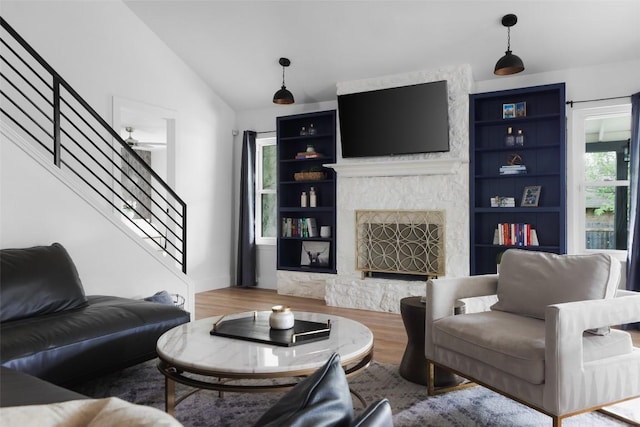 6307 Cannonleague Dr, Austin, TX 78745 - living area with stairs, wood finished floors, vaulted ceiling, a fireplace, and built in features