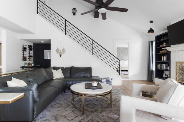 6307 Cannonleague Dr, Austin, TX 78745 - living area with a ceiling fan, stairway, light wood-style flooring, high vaulted ceiling, and built in features