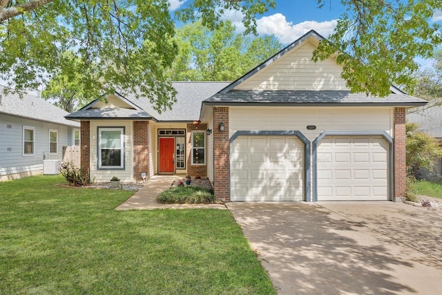 view of front of house featuring an attached garage, brick siding, and a front lawn