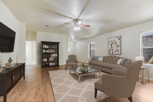 402 Washington Square Dr, Leander, TX 78641 - living area featuring a ceiling fan, light wood-type flooring, vaulted ceiling, and baseboards
